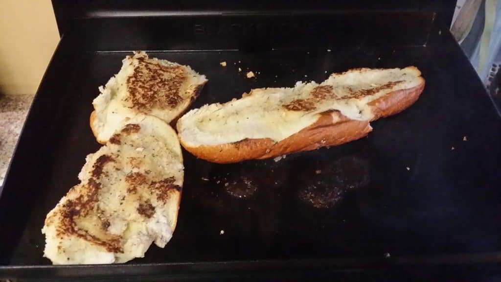 Garlic bread browning directly on the griddle top